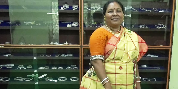 Dr. Dulee Hembram of the Dept. of Santali demonstrating a trove of jewellery used by adivasi women in ethnic festivals.